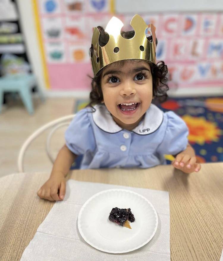 smiling preschooler wearing a crown